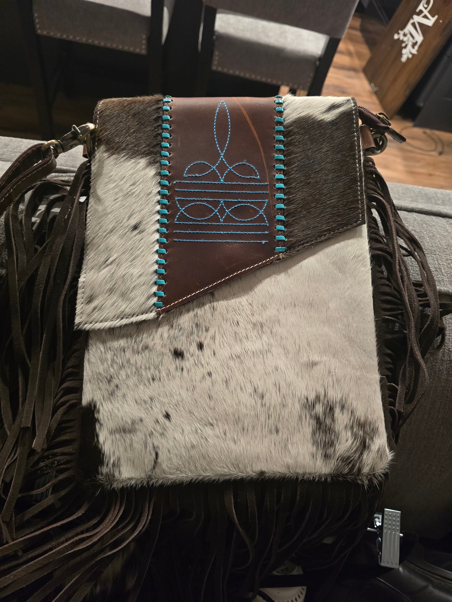 Boot stitch cowhide and fringe shoulder bag